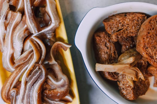 Detailed view of traditional Asian cuisine ingredients including meat strips and bean curd.
