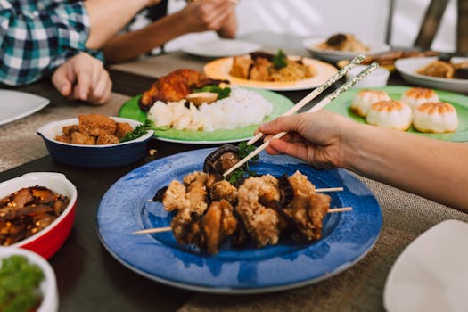 Savor the appeal of Asian cuisine with diverse dishes and chopsticks in use for an authentic touch.