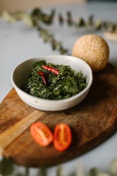 Delicious seaweed salad served with sesame ball and tomatoes on wooden board.