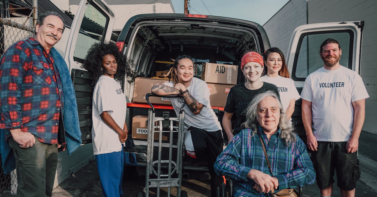 Photo by RDNE Stock project A diverse group of volunteers packing aid supplies into a van for donation.