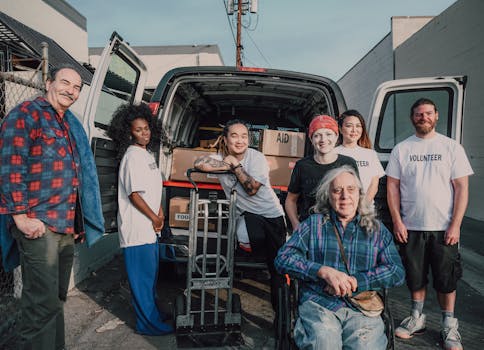 Photo by RDNE Stock project A diverse group of volunteers packing aid supplies into a van for donation.