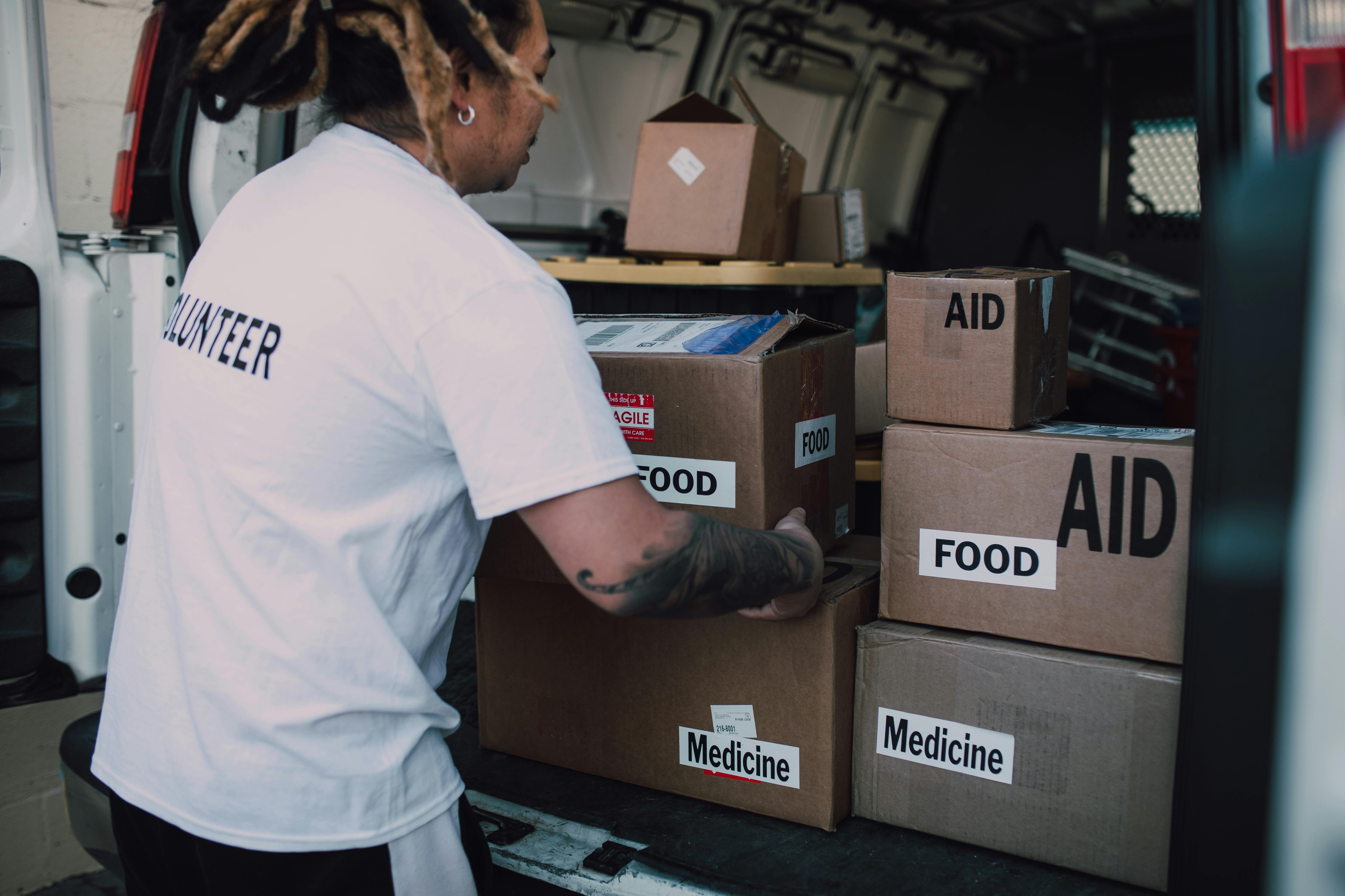 a person holding a cardboard box with food label