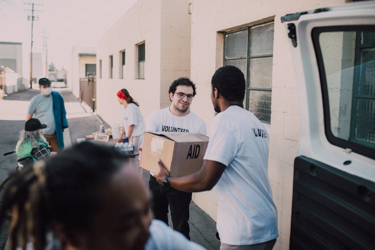 
Volunteers Passing Boxes To Each Other