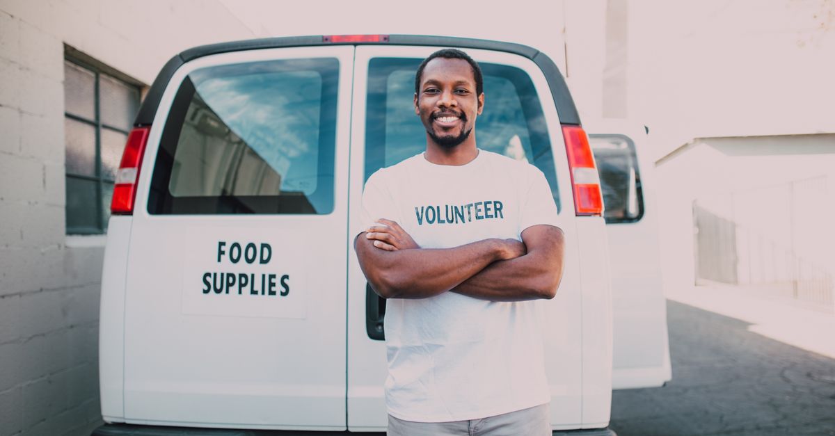 volunteer serving food at a community outreach table