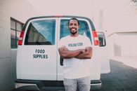Man in White Crew Neck T-shirt Standing Beside White Van