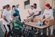 Man in White Crew Neck T-shirt Sitting on Black Wheelchair