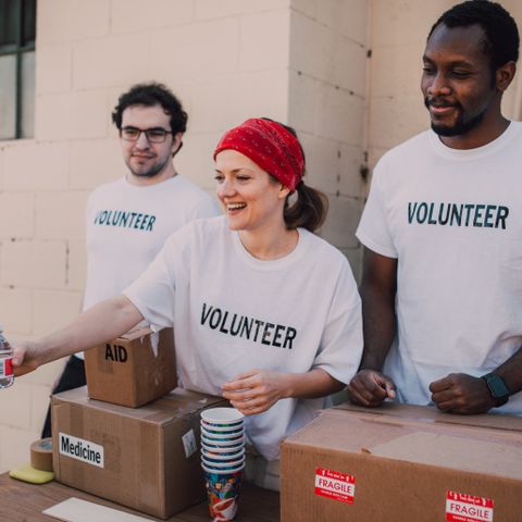 Volunteers with donation boxes — community champions