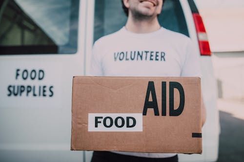 A Male Volunteer Carrying a Box