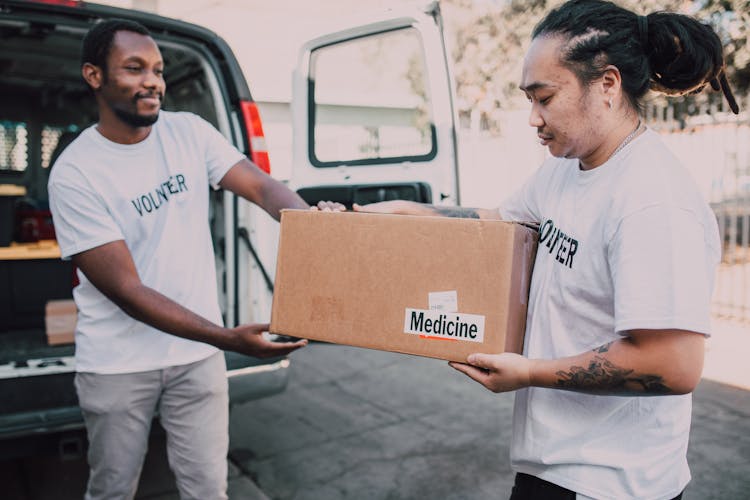 Two Men Carrying A Box