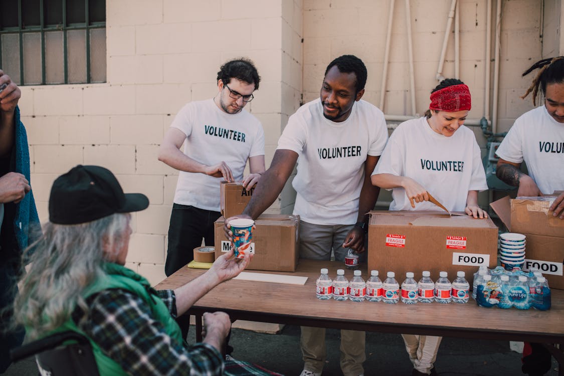 Free Volunteers Giving Donations Stock Photo