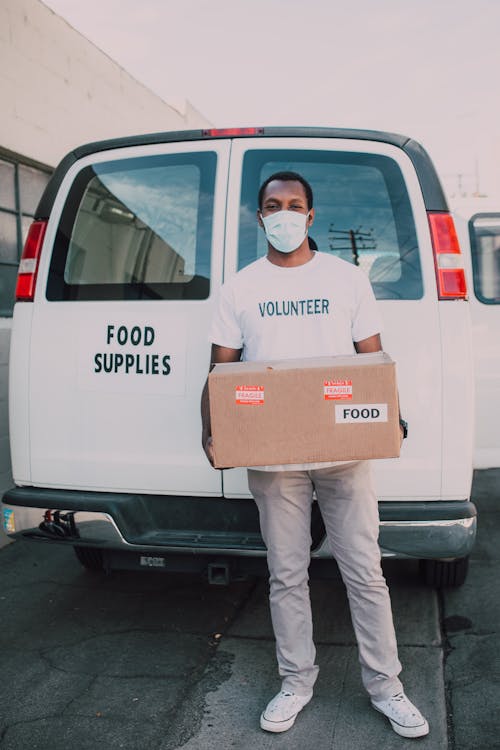 A Male Volunteer Carrying a Box