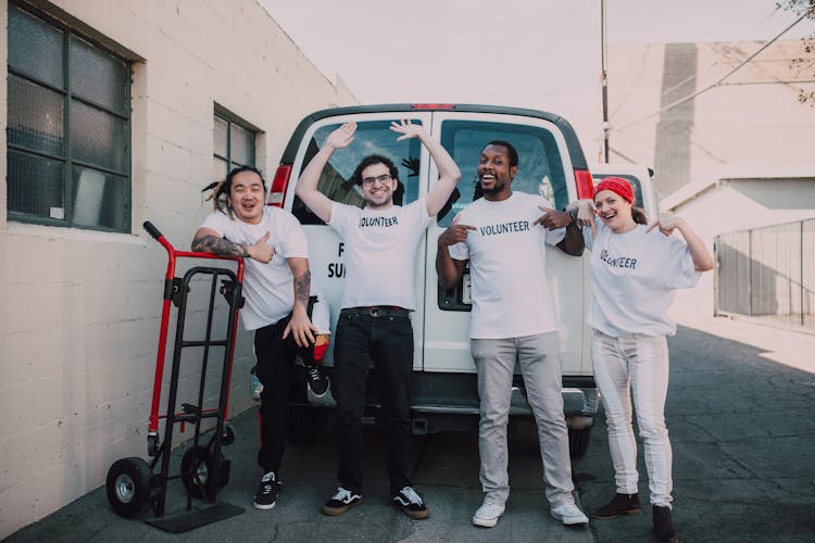 A Group Of Volunteers Wearing White Shirts