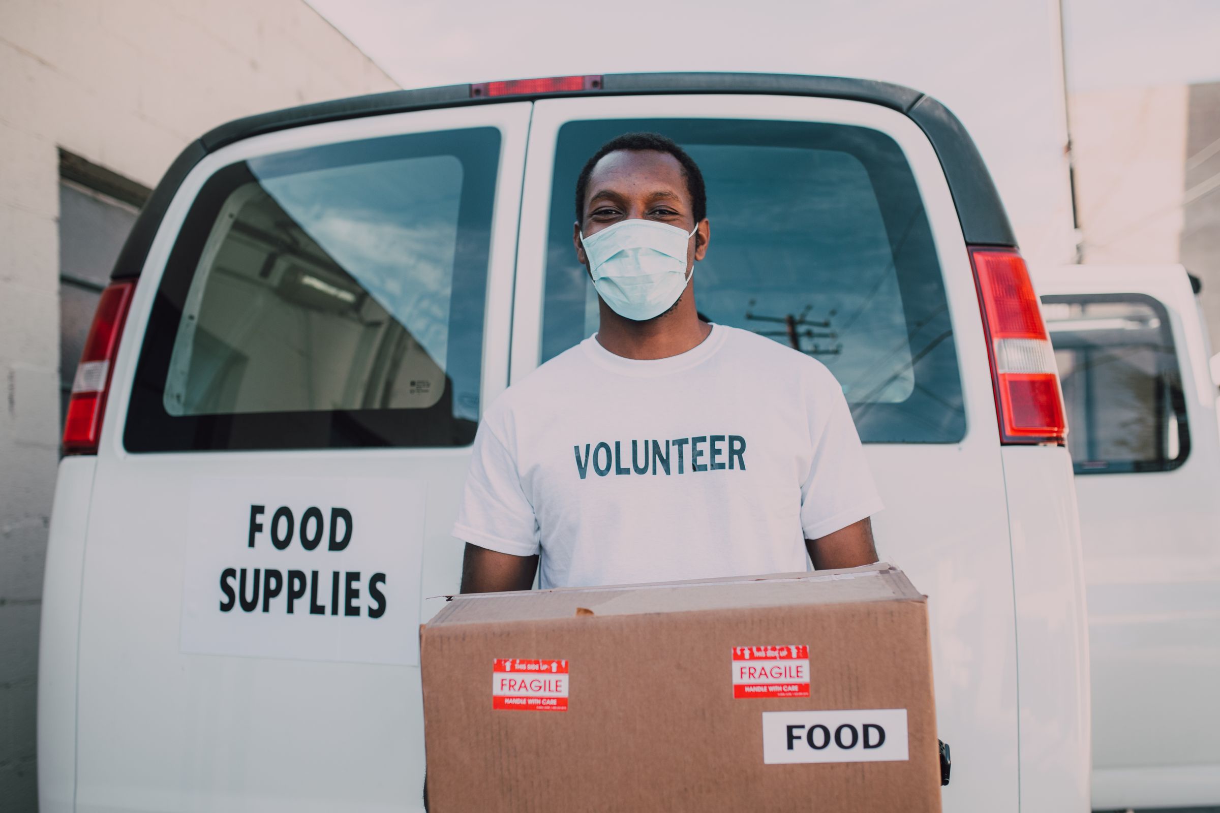Volunteer distributing food supplies during community relief efforts