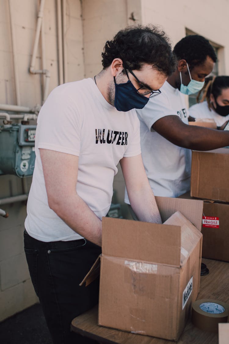 Men Volunteering In Packing Relief Goods