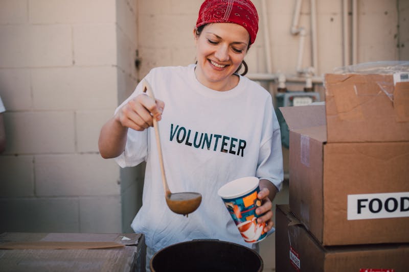 Volunteer serving food at donation center