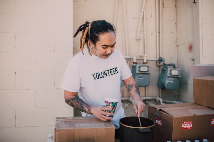 A Tattooed Volunteer Cooking