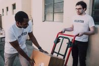 Men Moving Boxes with a Pushcart