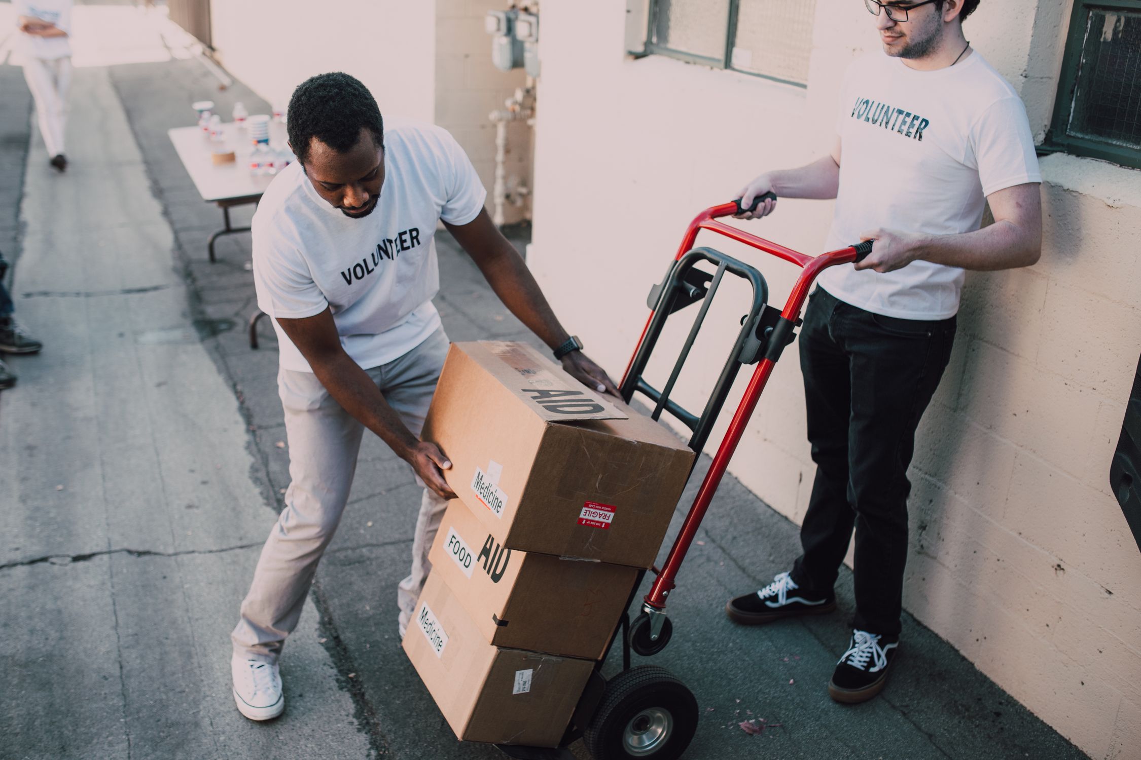 Two Men Carrying Boxes · Free Stock Photo