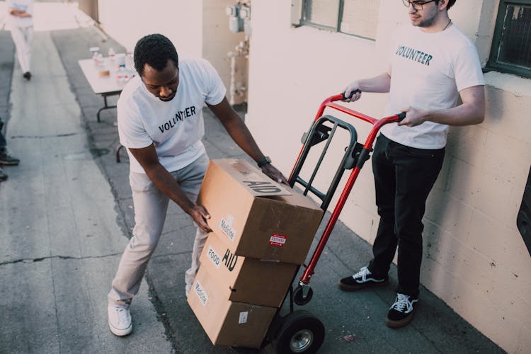 Two Men Carrying Boxes