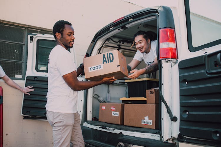 Two Men Carrying Boxes