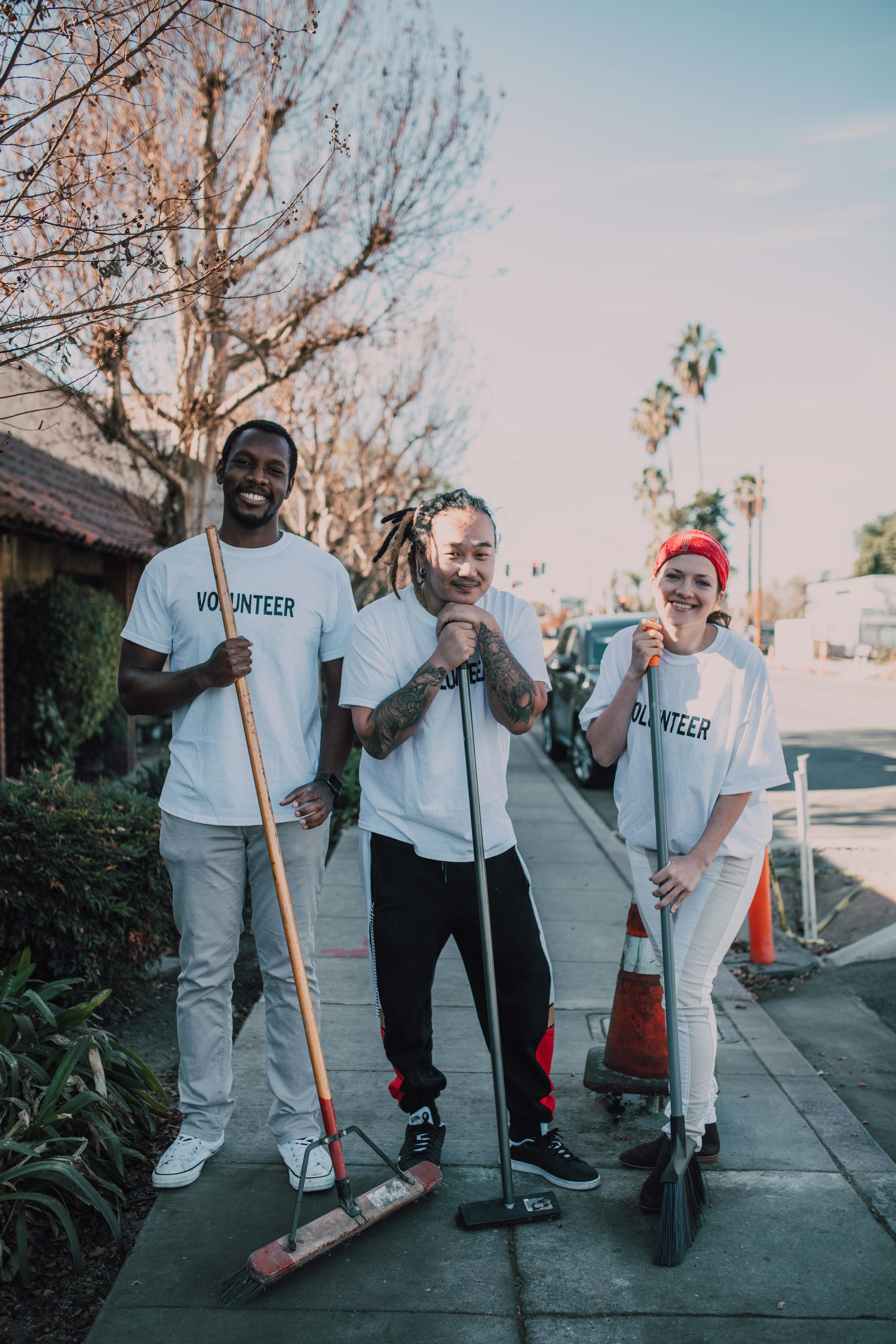 Photo of People Holding Broomsticks