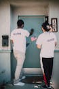 Two Men Knocking on the Blue Door