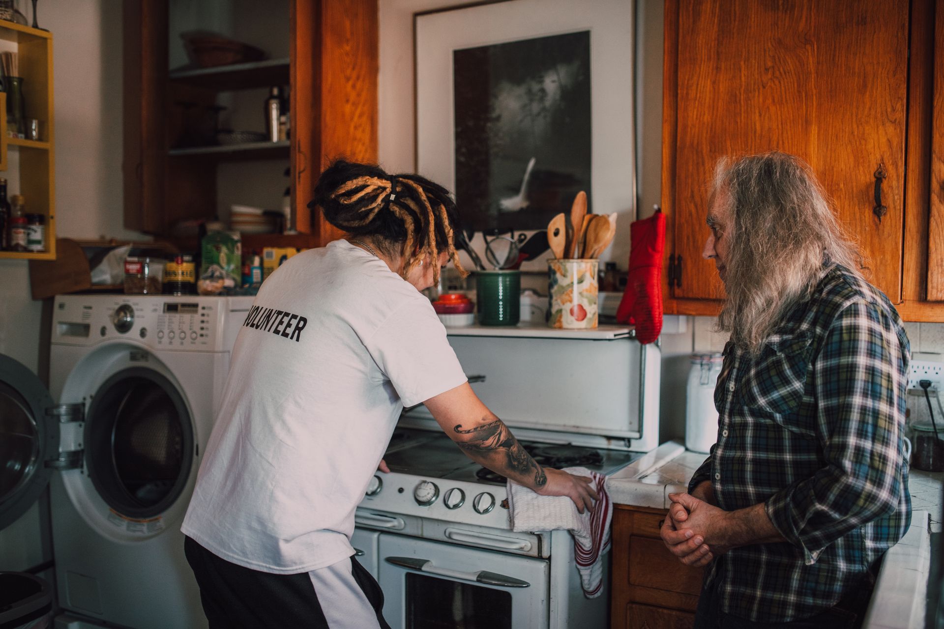 A Man Helping an Elderly Man Cleaning his Kitchen