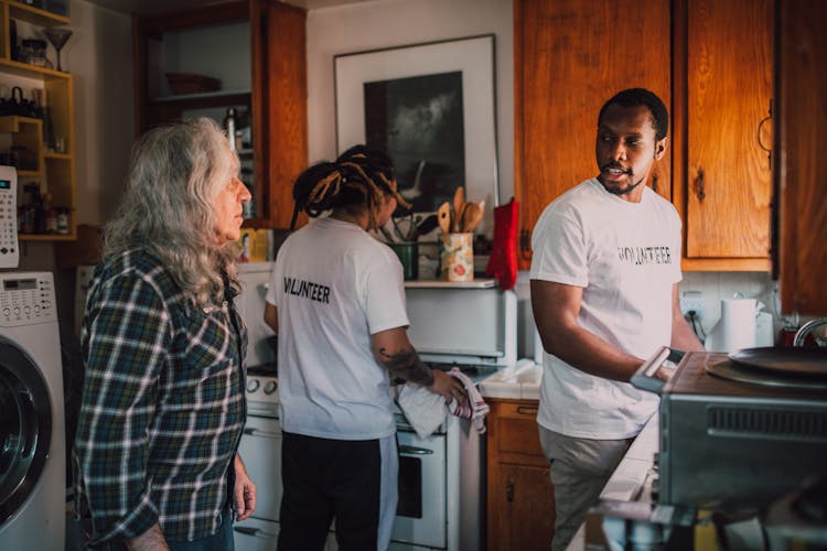 Volunteer Men Cleaning The Kitchen