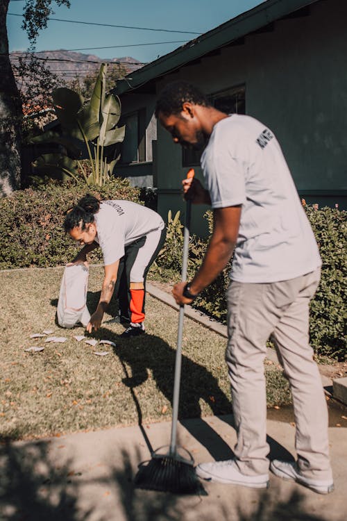 Free Volunteers Cleaning a Lawn Stock Photo