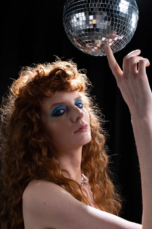 Portrait of Redhead Woman Holding Disco Ball