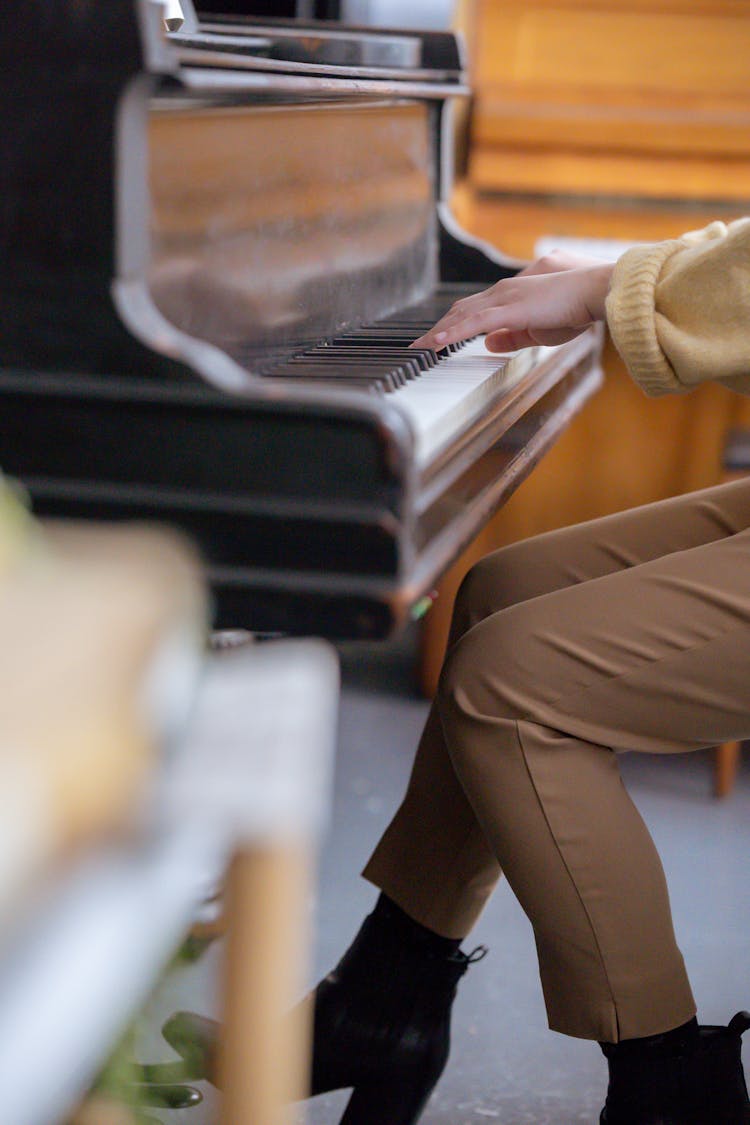 Faceless Lady Practicing Music On Piano In Classroom