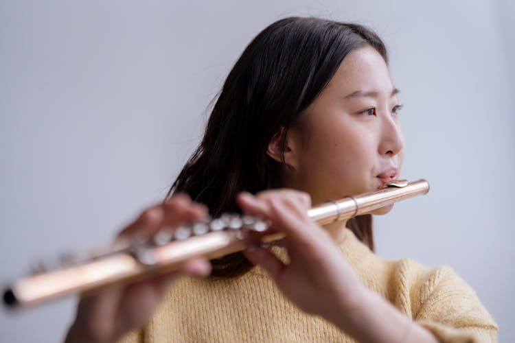 Ethnic Female Musician Playing On Flute