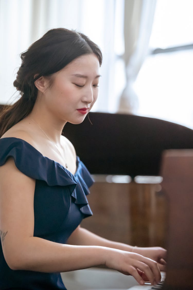 Charming Asian Musician Playing Piano