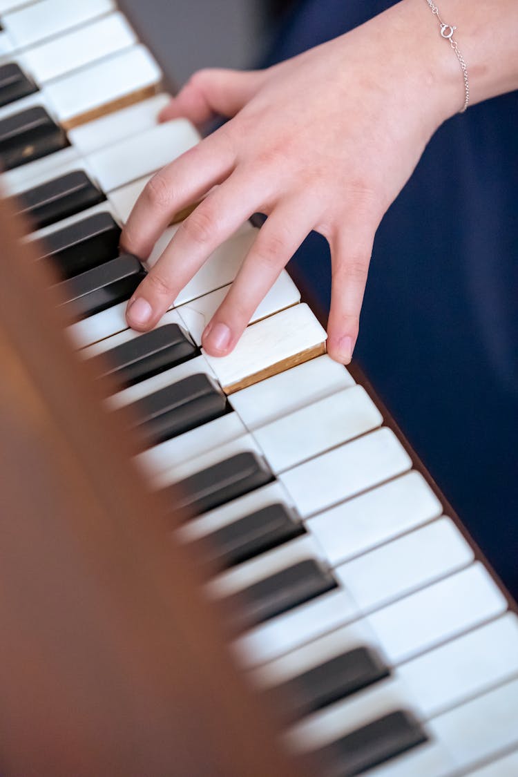 Woman Playing Piano At Concert Hall