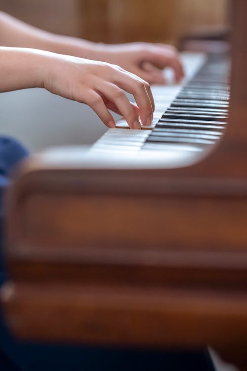 Woman playing piano while rehearsing melody