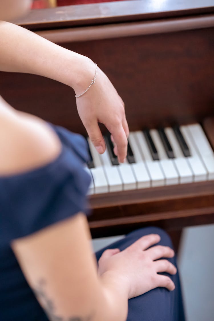 Woman Leaning On Piano At Concert