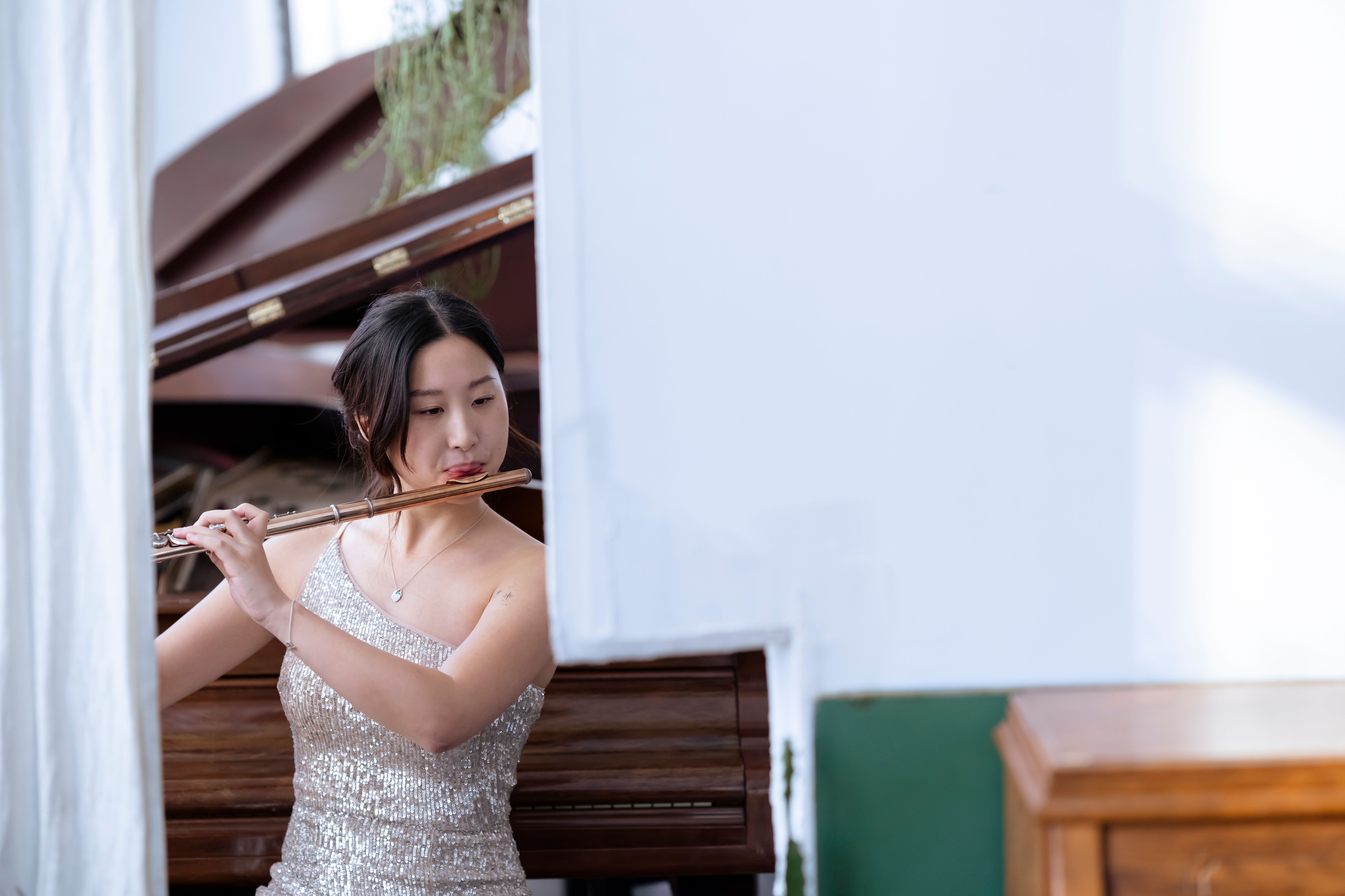A split image showing a classical composer at a piano on one side, and glowing, flowing data visualizations representing AI algorithms on the other