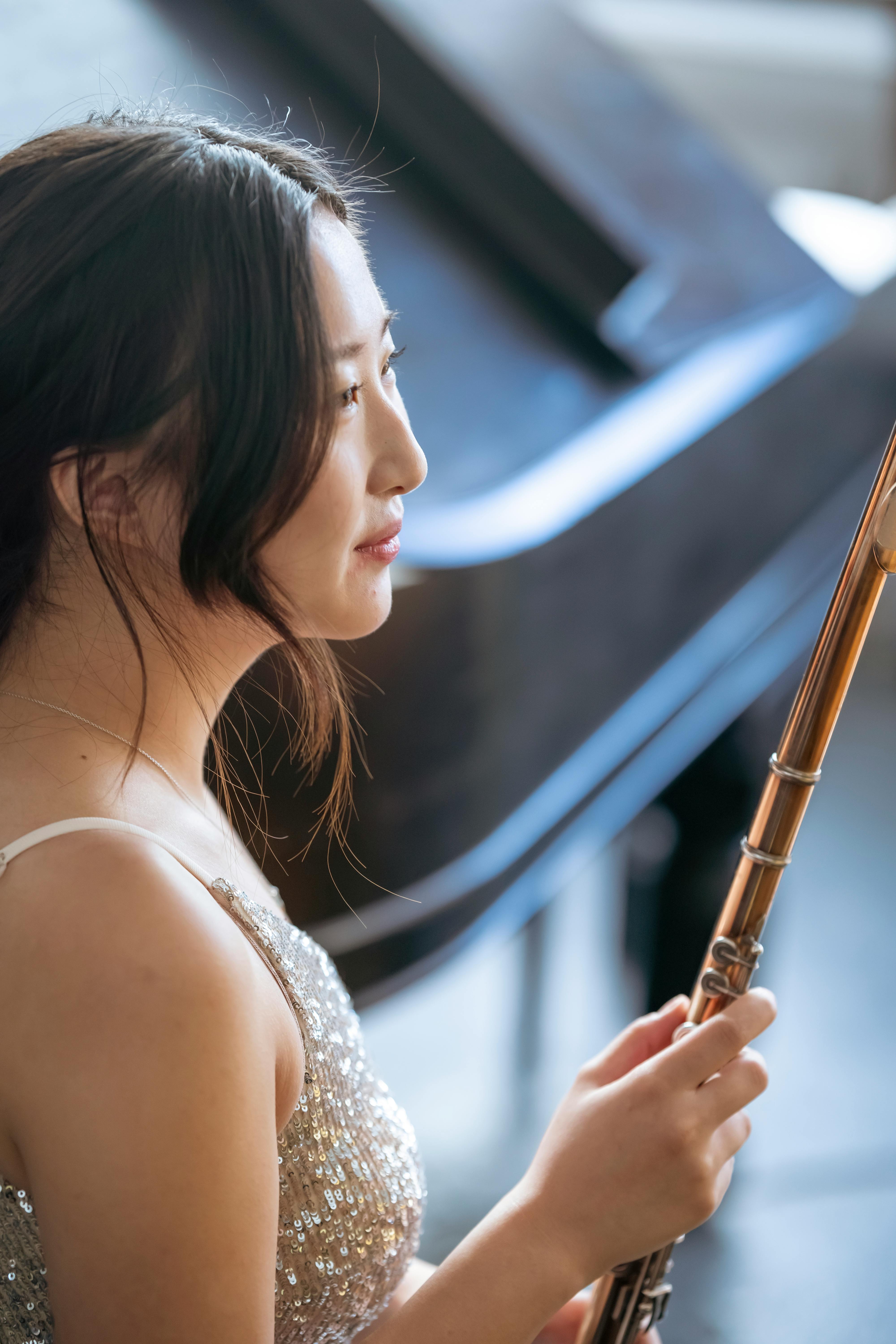 cheerful asian player with flute