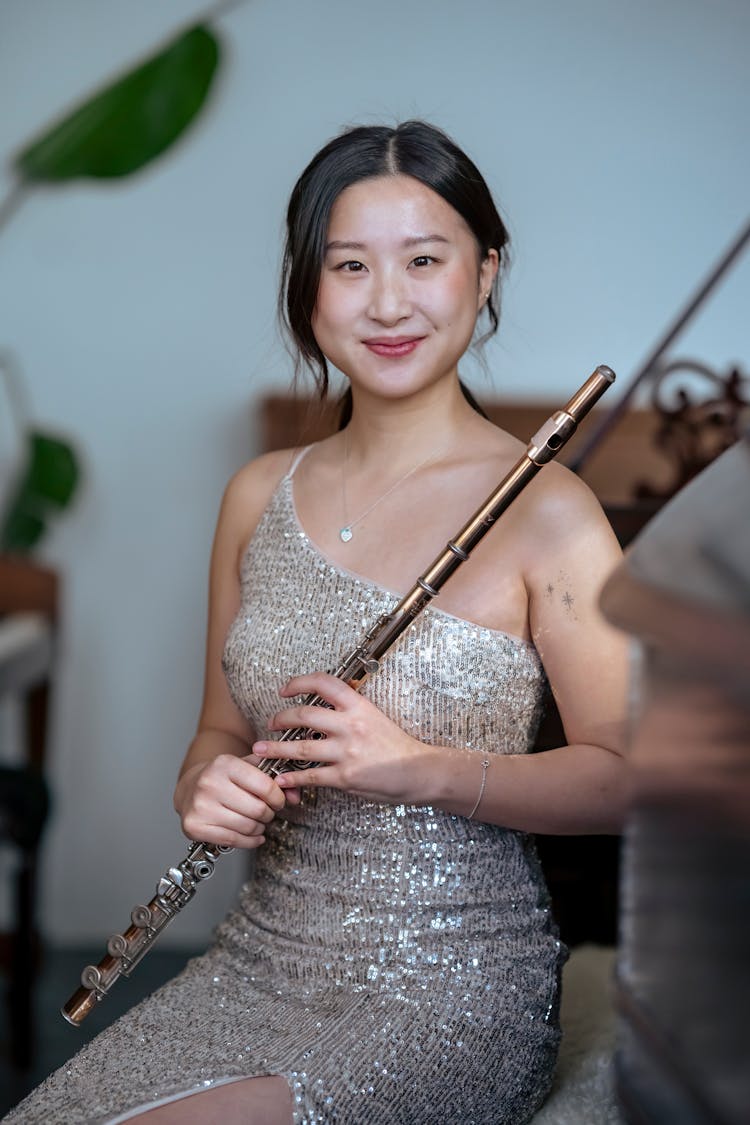 Smiling Asian Musician In Dress With Flute