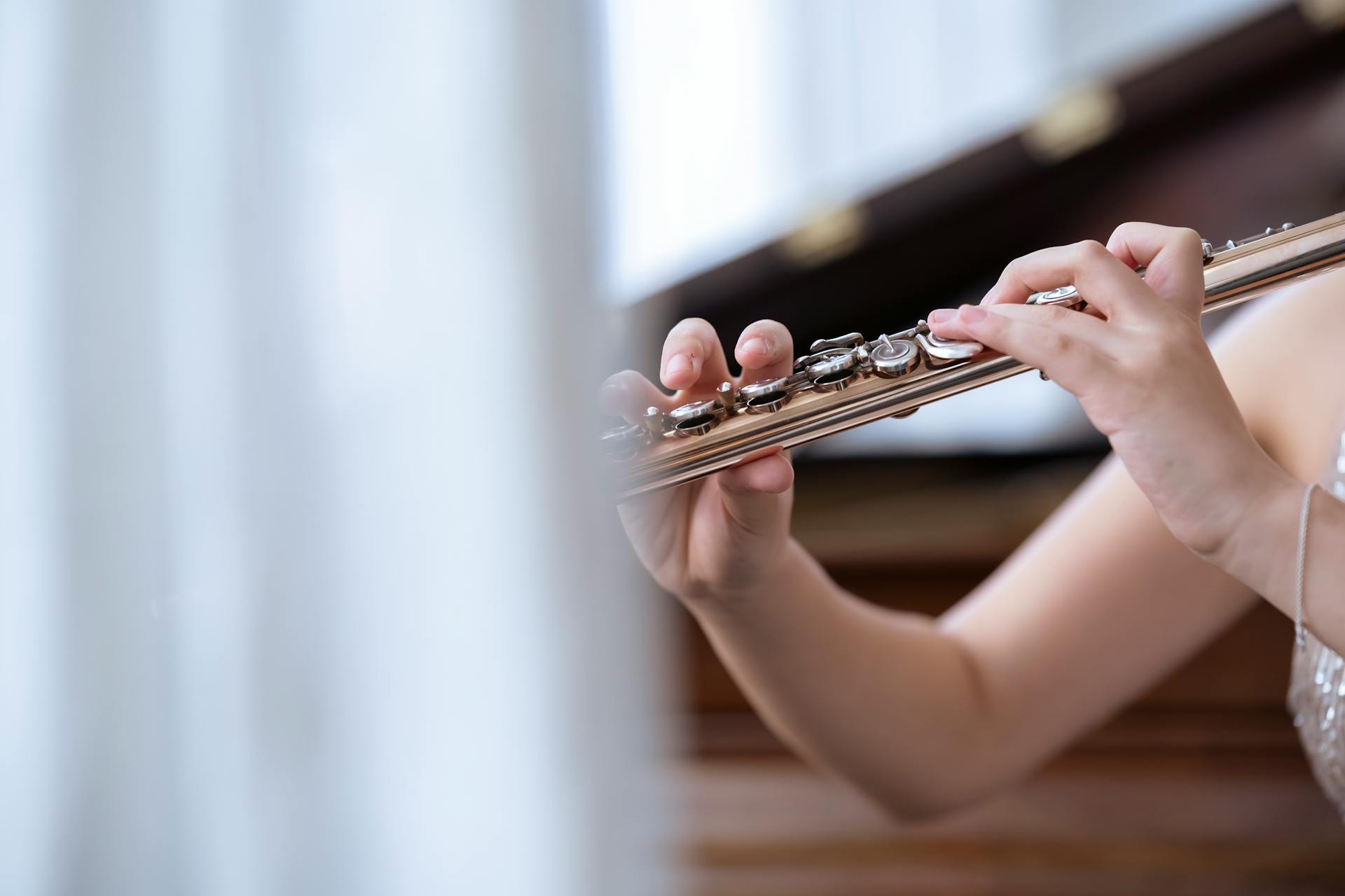 Woman playing flute in concert hall