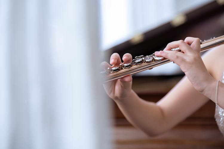 Woman Playing Flute In Concert Hall