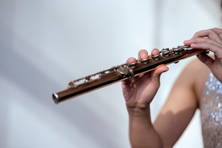 Woman In Sparkling Dress Playing Flute