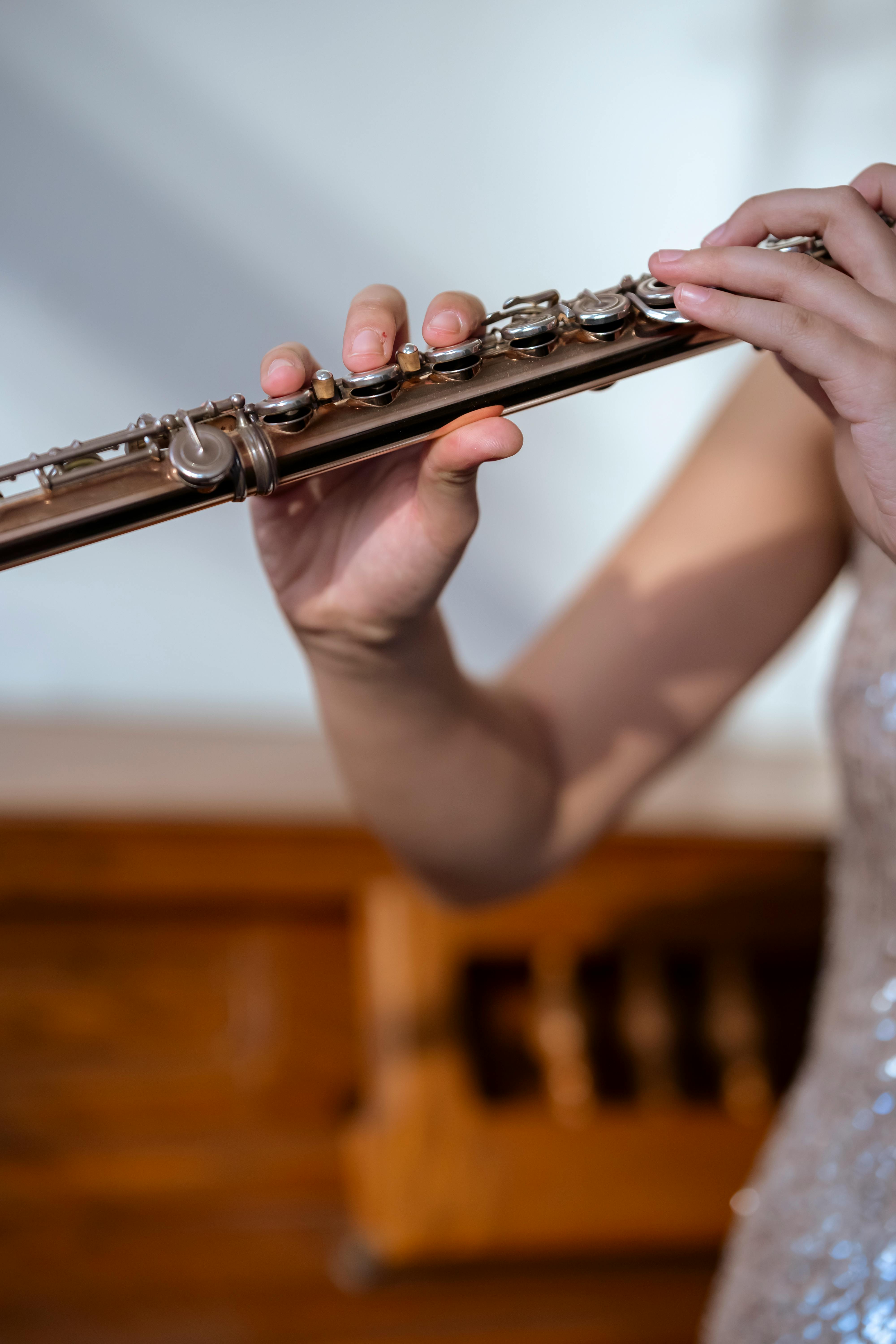 woman playing flute in light room