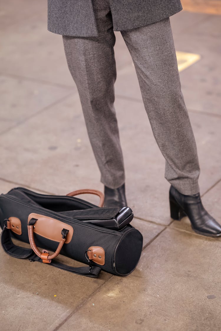 Woman In Formal Suit Standing In Street Near Bag