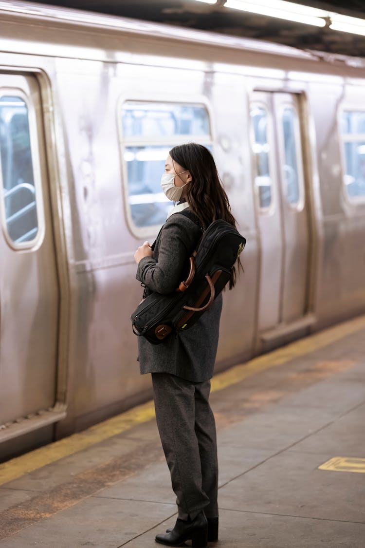 Woman In Medical Mask Waiting For Train On Platform