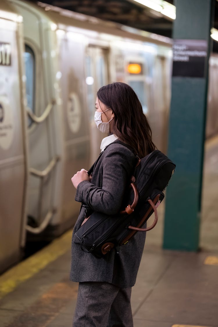 Woman In Mask Waiting For Train