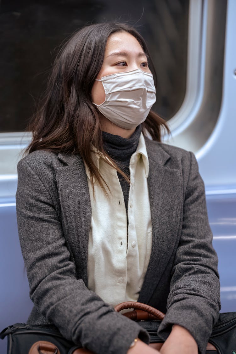 Young Woman In Medical Mask In City