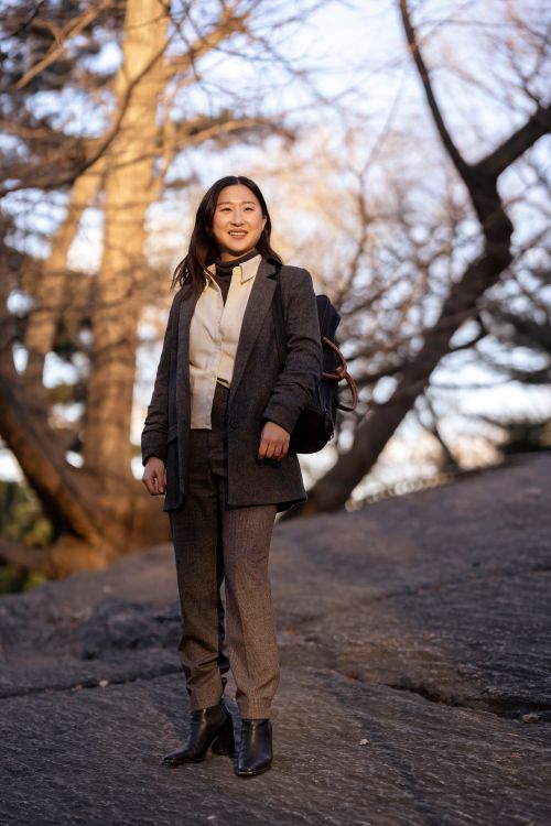 A Woman in Black Blazer and Brown Pants Standing Near Trees · Free ...