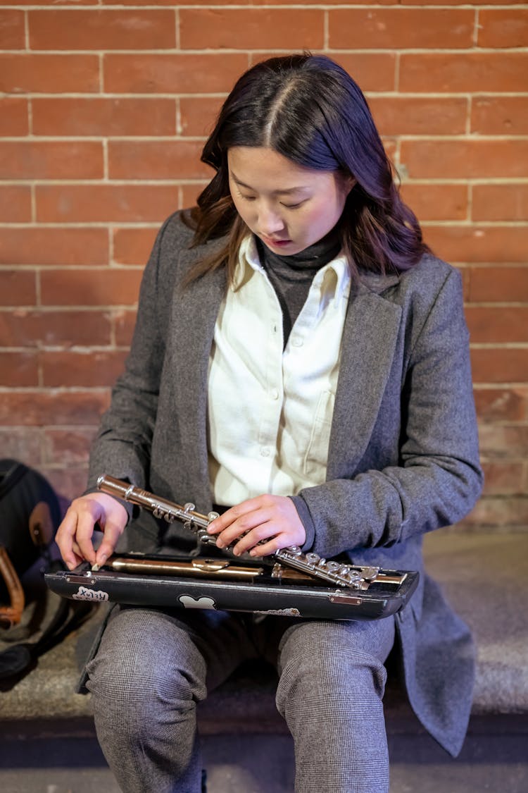 Ethnic Woman Taking Instrument From Case