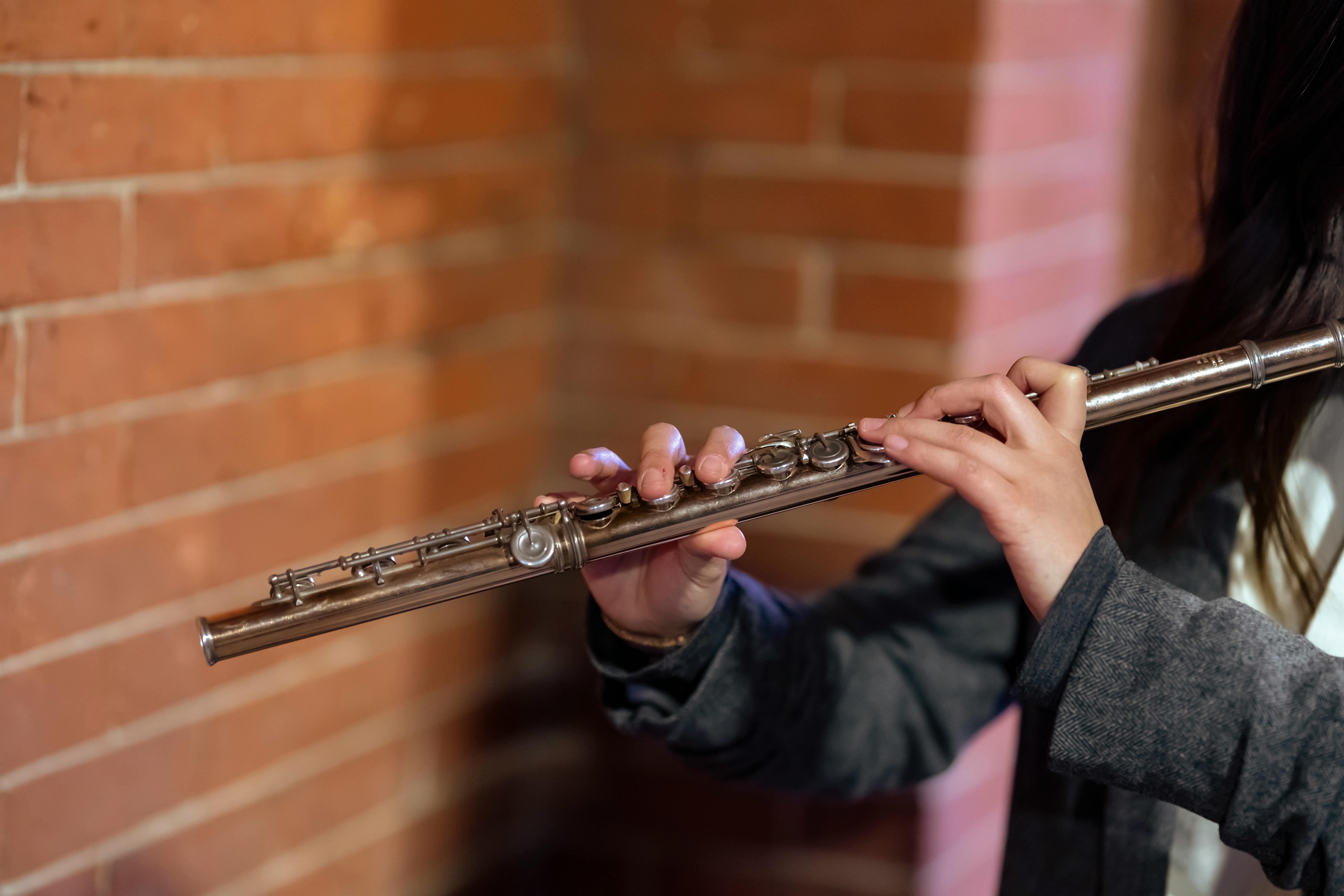 woman playing flute during live performance